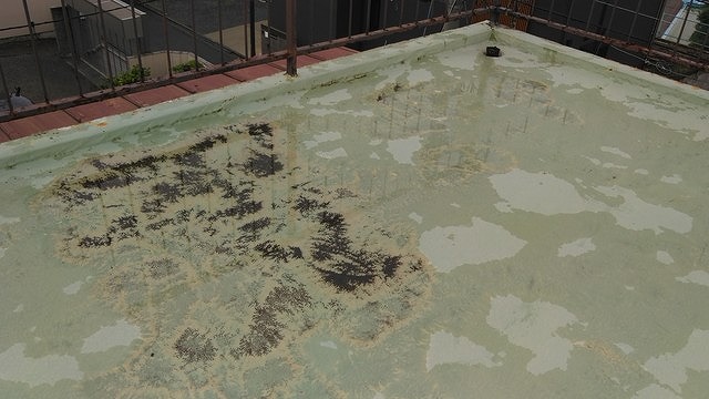 屋上の塗料防水の下地の黒いところが見えている